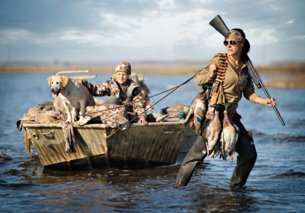 Beavertail Female pulling Child and Dog in 20' Custom Aluminum Flat Bottom Boat Lifestyle for Duck Hunting